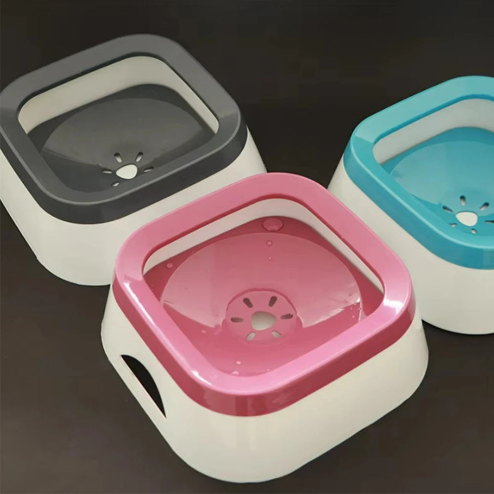 Three colorful pet bowls on a dark background