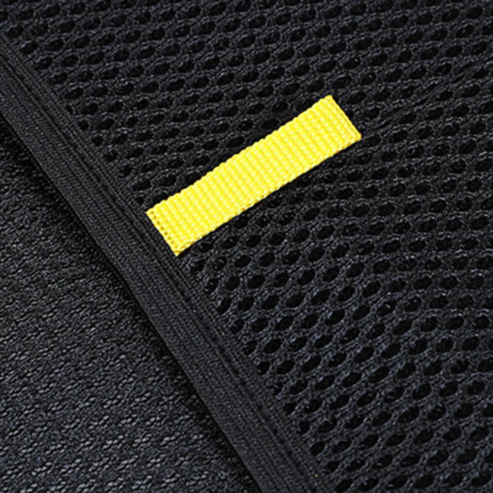 Close-up of a black textured surface with a yellow stripe

